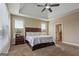 Spacious main bedroom with tray ceiling, large windows, and dark wood furniture at 2076 Towne Mill Ave, Canton, GA 30114