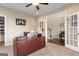 Office space with a large desk, ceiling fan, carpeted floor, and natural lighting at 2076 Towne Mill Ave, Canton, GA 30114