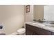 Elegant powder room featuring a vanity with a granite countertop and classic fixtures at 2076 Towne Mill Ave, Canton, GA 30114