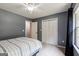 This bedroom has a large window, ceiling fan, neutral carpet and a gray painted walls at 3775 Highway 16 E, Sharpsburg, GA 30277