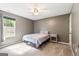 Comfortable bedroom featuring carpet, a ceiling fan, and a window overlooking the outdoor greenery at 3775 Highway 16 E, Sharpsburg, GA 30277