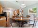 A cozy dining area features a wood table with seating for four near the kitchen and a window with natural light at 3775 Highway 16 E, Sharpsburg, GA 30277