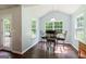 Bright dining area with dark wood floors featuring a view of lush greenery at 3775 Highway 16 E, Sharpsburg, GA 30277