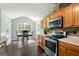 Eat-in kitchen with stainless steel appliances and stone backsplash at 3775 Highway 16 E, Sharpsburg, GA 30277