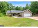 Charming single-story home with a well-maintained lawn, blossoming landscaping, and an attached two-car garage at 3775 Highway 16 E, Sharpsburg, GA 30277