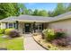 Charming front entrance with a well-manicured walkway and lush landscaping featuring colorful plants and decorative touches at 3775 Highway 16 E, Sharpsburg, GA 30277