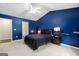 The main bedroom showcases a large bed, blue walls, vaulted ceiling, and carpet at 3775 Highway 16 E, Sharpsburg, GA 30277