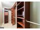This walk-in closet has custom wooden shelving, storage, and a rod for hanging clothes at 3775 Highway 16 E, Sharpsburg, GA 30277