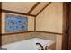 Bathroom tub with tile backsplash and ceiling and decorative artwork at 460 Morgan Mill Rd, Brooks, GA 30205