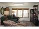 Cozy living room featuring wood walls, comfortable seating, and natural light from large windows at 460 Morgan Mill Rd, Brooks, GA 30205