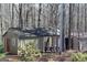 View of outbuildings amongst a treed lot at 460 Morgan Mill Rd, Brooks, GA 30205