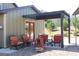 Outdoor seating area with comfortable chairs, a fire pit, and a pergola providing shade at 460 Morgan Mill Rd, Brooks, GA 30205