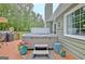 Backyard deck with a hot tub, outdoor seating, and green foliage at 175 Thomas Overby Dr, Sharpsburg, GA 30277