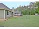 View of a spacious backyard, deck, shed, landscaping, and a fenced in area at 175 Thomas Overby Dr, Sharpsburg, GA 30277