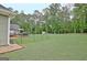 Expansive backyard featuring a deck, storage shed, and outdoor seating area at 175 Thomas Overby Dr, Sharpsburg, GA 30277