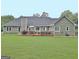 Large backyard with deck, landscaping, and well-maintained lawn at 175 Thomas Overby Dr, Sharpsburg, GA 30277