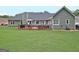 Expansive backyard features a large deck with outdoor seating, offering an ideal space for relaxation and entertaining at 175 Thomas Overby Dr, Sharpsburg, GA 30277