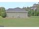Side view of the backyard with trees, privacy fence, and lush landscaping at 175 Thomas Overby Dr, Sharpsburg, GA 30277