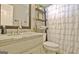 Bright bathroom featuring a modern vanity, rustic ladder shelves, and a charming shower curtain at 175 Thomas Overby Dr, Sharpsburg, GA 30277