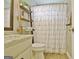 Bright bathroom featuring a modern vanity, rustic ladder shelves, and a charming shower curtain at 175 Thomas Overby Dr, Sharpsburg, GA 30277