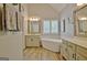 Bright bathroom featuring soaking tub and double sink vanity at 175 Thomas Overby Dr, Sharpsburg, GA 30277
