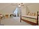 Bright attic bedroom featuring a ceiling fan, neutral paint, and plush carpet at 175 Thomas Overby Dr, Sharpsburg, GA 30277