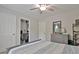 Neutral bedroom with a closet converted to a home office and a gray dresser with mirror at 175 Thomas Overby Dr, Sharpsburg, GA 30277