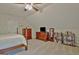 Attic bedroom boasts plush carpeting, a ceiling fan, and ample space for furnishings at 175 Thomas Overby Dr, Sharpsburg, GA 30277