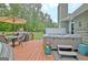 Entertain on the deck with a hot tub, dining set, and a tranquil view of the lush green lawn at 175 Thomas Overby Dr, Sharpsburg, GA 30277
