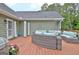 The deck includes seating, a door to enter the home, and plants at 175 Thomas Overby Dr, Sharpsburg, GA 30277