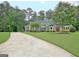 View of the lovely landscaped lawn and beautiful exterior of this home at 175 Thomas Overby Dr, Sharpsburg, GA 30277