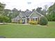 Charming home featuring a well-maintained lawn, tasteful landscaping and shutters at 175 Thomas Overby Dr, Sharpsburg, GA 30277
