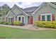 Close up of the front entrance to a lovely home with a lush lawn and a stone entryway at 175 Thomas Overby Dr, Sharpsburg, GA 30277
