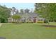 Charming home featuring a well-maintained lawn and tastefully landscaped front yard at 175 Thomas Overby Dr, Sharpsburg, GA 30277