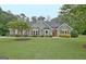 Charming home featuring a well-maintained lawn, tasteful landscaping, and classic shutters at 175 Thomas Overby Dr, Sharpsburg, GA 30277