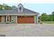 View of the garage with access door and driveway at 175 Thomas Overby Dr, Sharpsburg, GA 30277