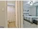 Hallway view showcasing access to a bathroom with a shower and a bedroom at 175 Thomas Overby Dr, Sharpsburg, GA 30277