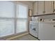 Charming laundry room with white washer and dryer at 175 Thomas Overby Dr, Sharpsburg, GA 30277