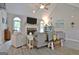 This living room is enhanced by a vaulted ceiling and bright windows at 175 Thomas Overby Dr, Sharpsburg, GA 30277