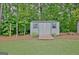 Outdoor storage shed in a wooded area with a pull-up bar and wood storage at 175 Thomas Overby Dr, Sharpsburg, GA 30277