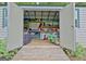 Interior of outdoor storage shed with shelves, lawnmower, tools, and equipment at 175 Thomas Overby Dr, Sharpsburg, GA 30277
