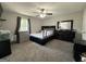 Comfortable bedroom with neutral carpet, ceiling fan, and dark furniture at 3456 Village Glen Ct, Snellville, GA 30039