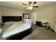 Comfortable bedroom with ceiling fan, carpet, and queen sized bed with black frame at 3456 Village Glen Ct, Snellville, GA 30039