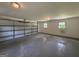 Empty garage with gray concrete floor and closed garage door with two windows at 3456 Village Glen Ct, Snellville, GA 30039