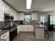 Functional kitchen featuring updated appliances, white cabinetry, and a view of the outdoors at 3456 Village Glen Ct, Snellville, GA 30039