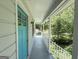 Inviting covered porch with white railings and a bright blue front door, offering a welcoming entrance at 3456 Village Glen Ct, Snellville, GA 30039