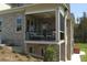 Covered balcony of a brick house with outdoor seating and view of landscaped yard at 315 Westbourne Dr, Tyrone, GA 30290