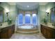 This bathroom features dual sinks, granite counters and a tub under a window at 315 Westbourne Dr, Tyrone, GA 30290
