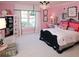 This pink bedroom features a black and white color scheme in the furniture and trim at 315 Westbourne Dr, Tyrone, GA 30290