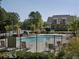 Community pool with lounge chairs and a view of the surrounding neighborhood at 315 Westbourne Dr, Tyrone, GA 30290